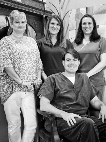 Dr. Herrington, a Meridian dental implant specialist, with his team.